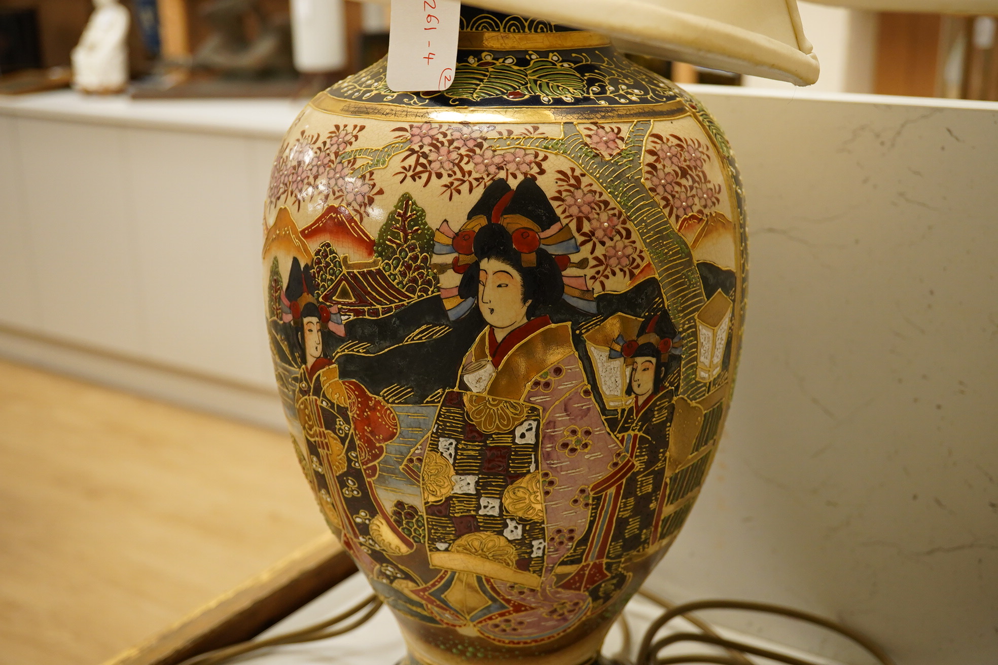 A pair of modern Japanese pottery table lamps, with cream shades, 77cm high including shade. Condition - good